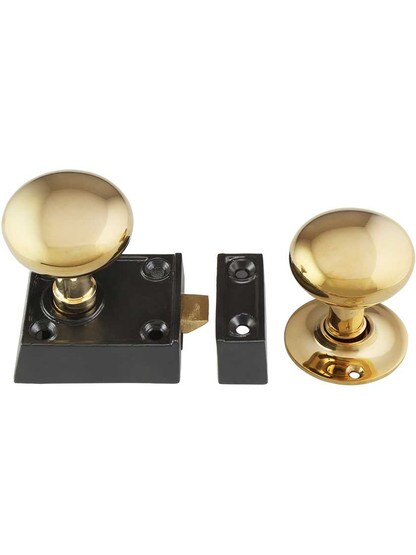 Small Cast Iron Rim Latch Set with Round Brass Knobs.